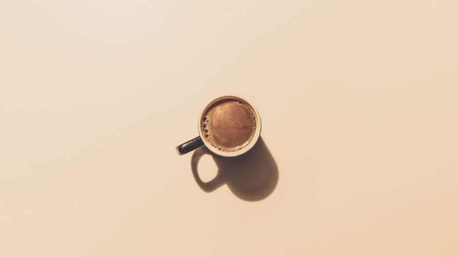 Cup of Coffee on Brown Surface Photography